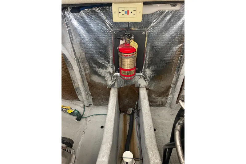 Slide: The Image of 2004 Carolina Classic 28 engine compartment with fire extinguisher and insulation. - 45