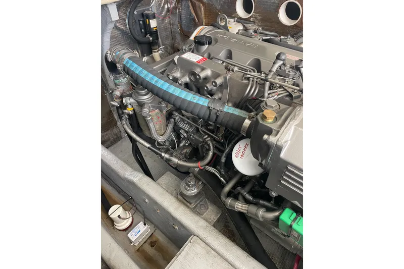 Slide: The Image of Engine compartment of a 2004 Carolina Classic 28 boat, showcasing detailed components. - 46