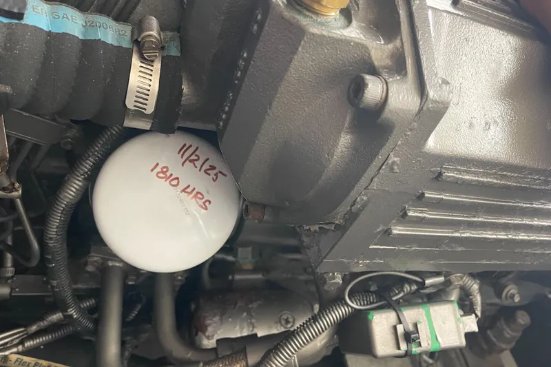 Slide: The Image of Engine compartment of a 2004 Carolina Classic 28 boat with visible oil filter. - 48