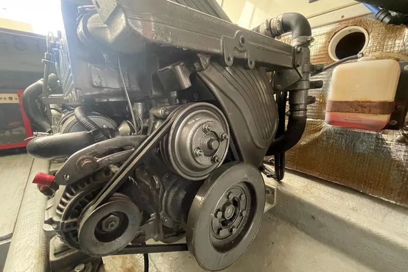 Slide: The Image of Engine of a 2004 Carolina Classic 28 boat, showcasing mechanical components. - 49