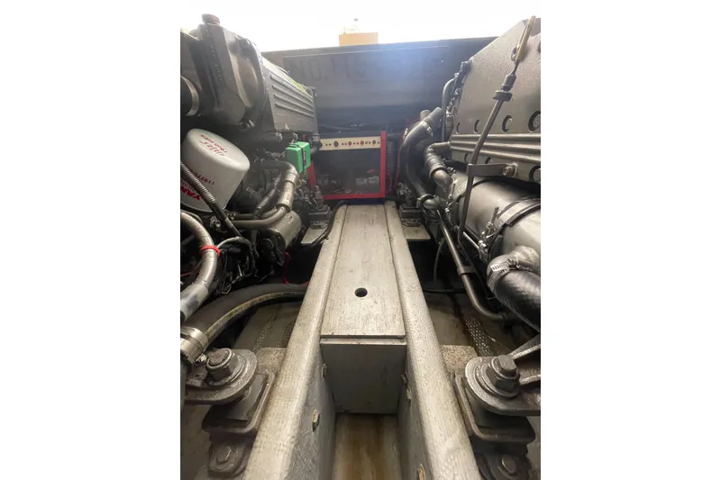 Slide: The Image of Engine compartment of a 2004 Carolina Classic 28 boat, showcasing mechanical components. - 52