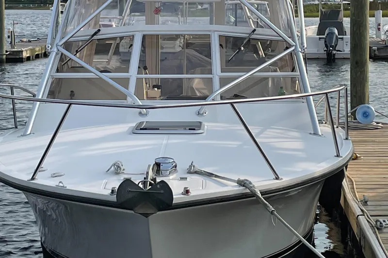 Slide: The Image of 2004 Carolina Classic 28 boat docked at marina, front view. - 54