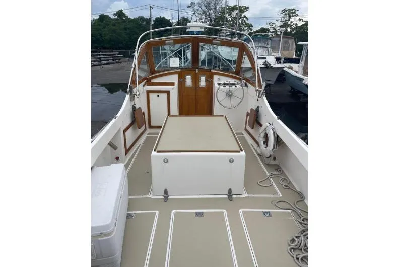 Slide: The Image of 1997 Wasque C.W. Hood Wasque 26 boat interior with wooden accents and steering wheel. - 10