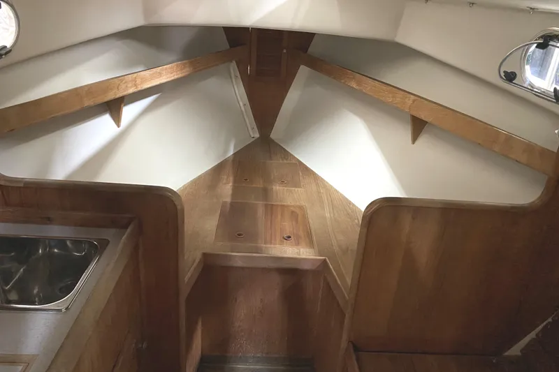 Slide: The Image of Interior of 1997 Wasque C.W.Hood Wasque 26 boat with wooden finish and compact design. - 15