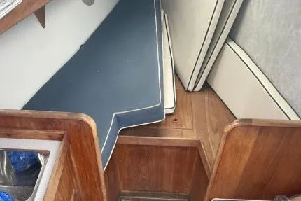 Slide: The Image of Interior of 1997 Wasque C.W. Hood Wasque 26 boat with wooden finish and cushions. - 16