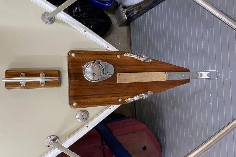 Slide: The Image of 1997 Wasque C.W.Hood Wasque 26 boat deck with wooden fittings and metal cleat. - 3