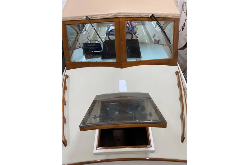 Slide: The Image of 1997 Wasque C.W. Hood Wasque 26 boat with tan canopy and wooden trim. - 4