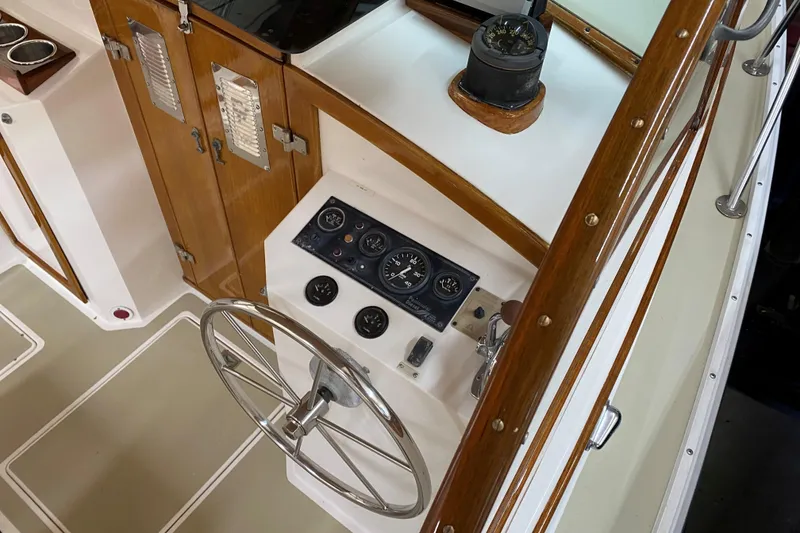 Slide: The Image of 1997 Wasque C.W. Hood Wasque 26 boat helm with wooden accents and instrument panel. - 6