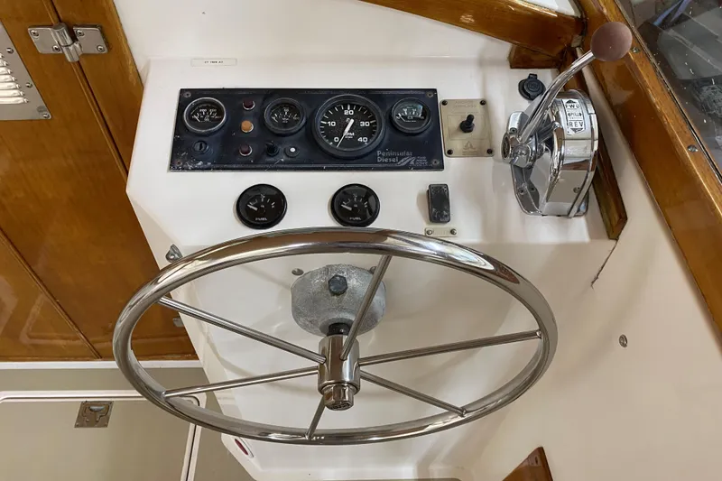Slide: The Image of Steering console of 1997 Wasque C.W.Hood Wasque 26 with gauges and controls. - 7