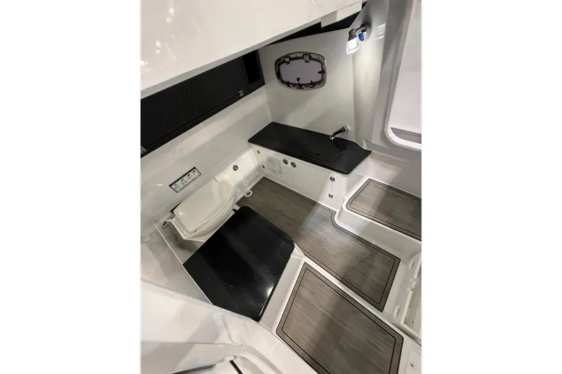 Slide: The Image of 2026 Monterey Elite 25 OB boat interior with modern amenities and sleek design. - 12