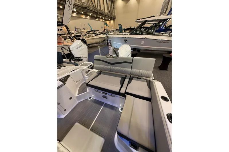 Slide: The Image of 2026 Monterey Elite 25 OB boat interior with seating and modern design at a boat show. - 16