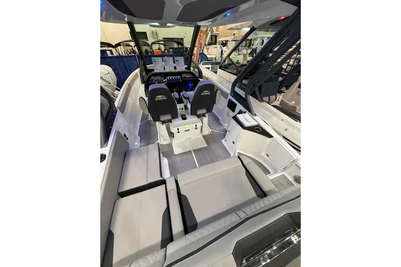 Slide: The Image of 2026 Monterey Elite 25 OB boat interior with modern seating and control panel. - 6