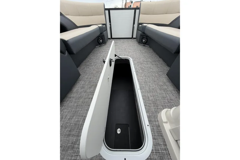 Slide: The Image of 2026 Flagship D22RF Ext. Deck boat interior with open storage compartment and seating. - 13