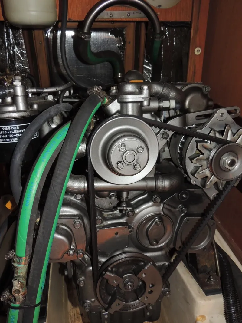 Slide: The Image of Engine of a 1999 Hunter 380 with hoses and belts. - 11