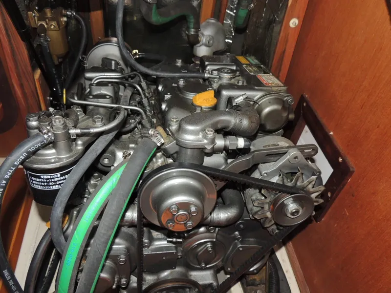 Slide: The Image of Engine compartment of a 1999 Hunter 380 with visible hoses and belts. - 12