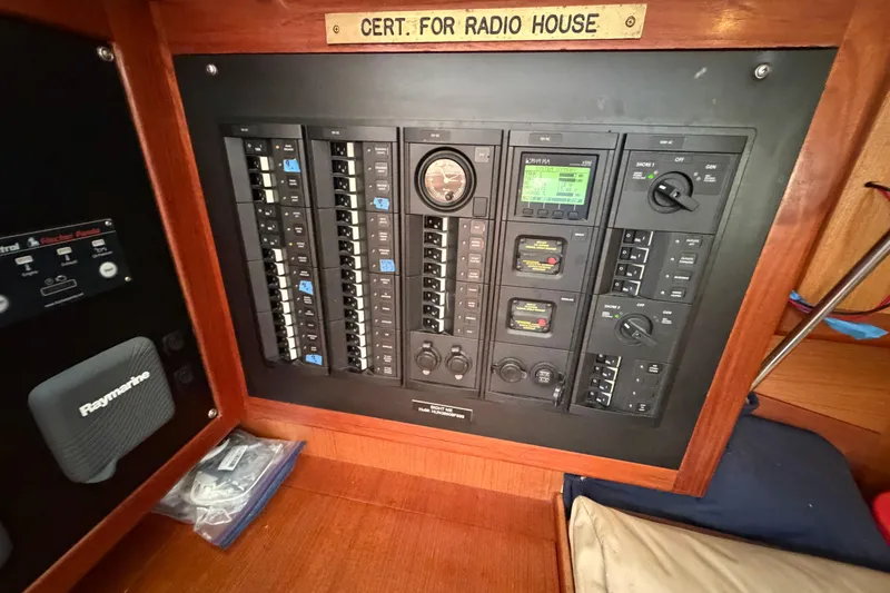 Slide: The Image of Electrical control panel on a 1999 Hunter 380 sailboat, featuring various switches and gauges. - 14