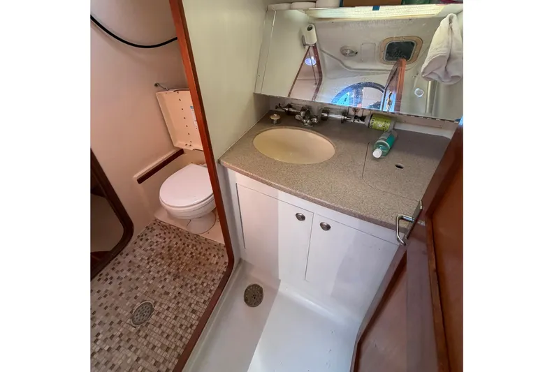 Slide: The Image of Bathroom interior of a 1999 Hunter 380 sailboat with sink and toilet. - 16
