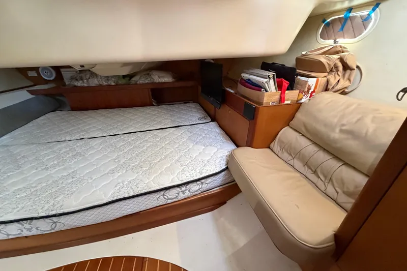 Slide: The Image of Cozy cabin interior of 1999 Hunter 380 sailboat with bed and seating area. - 19