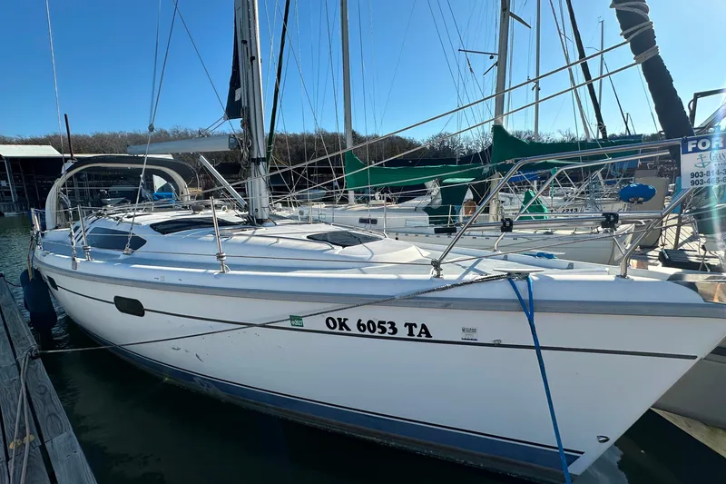 Slide: The Image of 1999 Hunter 380 sailboat docked at marina, clear sky, registration OK 6053 TA. - 4