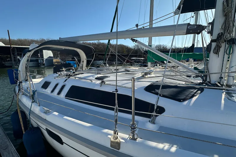 Slide: The Image of 1999 Hunter 380 sailboat docked at marina, featuring sleek design and modern rigging. - 5