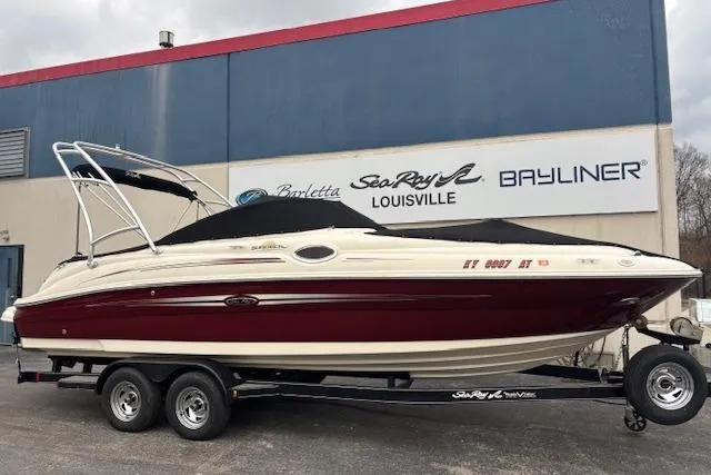 The Image of 2007 Sea Ray 240 Sundeck boat on trailer, parked outside dealership. - 1