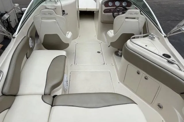Slide: The Image of 2007 Sea Ray 240 Sundeck interior with beige seating and dashboard controls. - 10