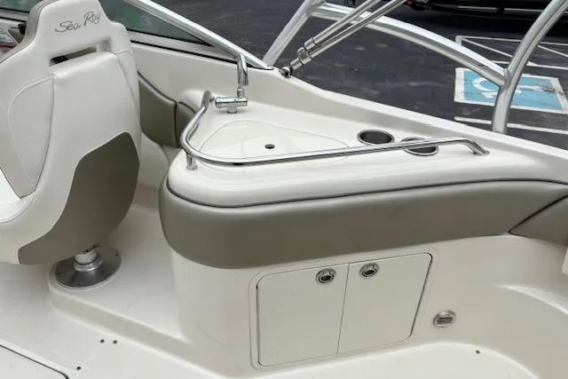 Slide: The Image of 2007 Sea Ray 240 Sundeck interior with seating and sink area. - 13