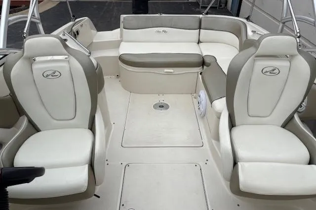 Slide: The Image of 2007 Sea Ray 240 Sundeck interior with white and gray seating arrangement. - 15