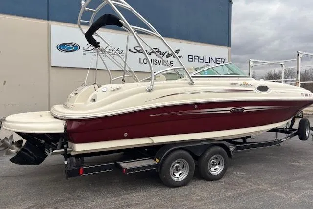 Slide: The Image of 2007 Sea Ray 240 Sundeck boat on trailer, parked outside dealership. - 3