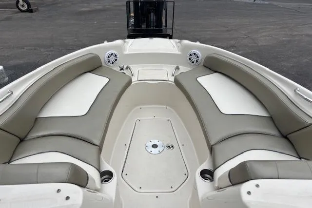 Slide: The Image of 2007 Sea Ray 240 Sundeck boat interior with cushioned seating and storage compartments. - 7