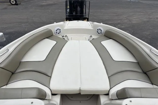 Slide: The Image of 2007 Sea Ray 240 Sundeck boat interior with cushioned seating and speakers. - 8
