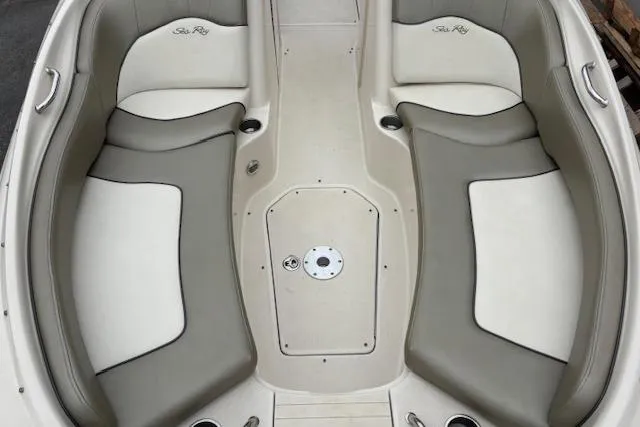 Slide: The Image of 2007 Sea Ray 240 Sundeck interior with beige and gray seating. - 9