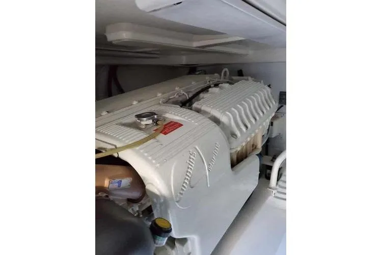 Slide: The Image of Engine compartment of a 2005 Luhrs 41 Convertible boat, showcasing a clean, white engine. - 12