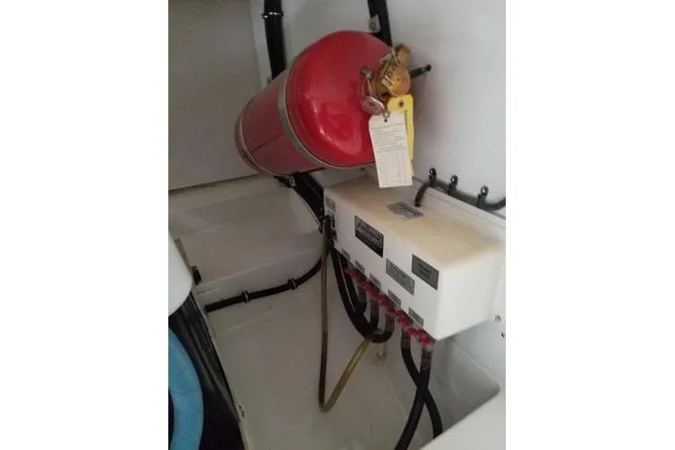 Slide: The Image of 2005 Luhrs 41 Convertible engine room with fire extinguisher and control panel. - 16