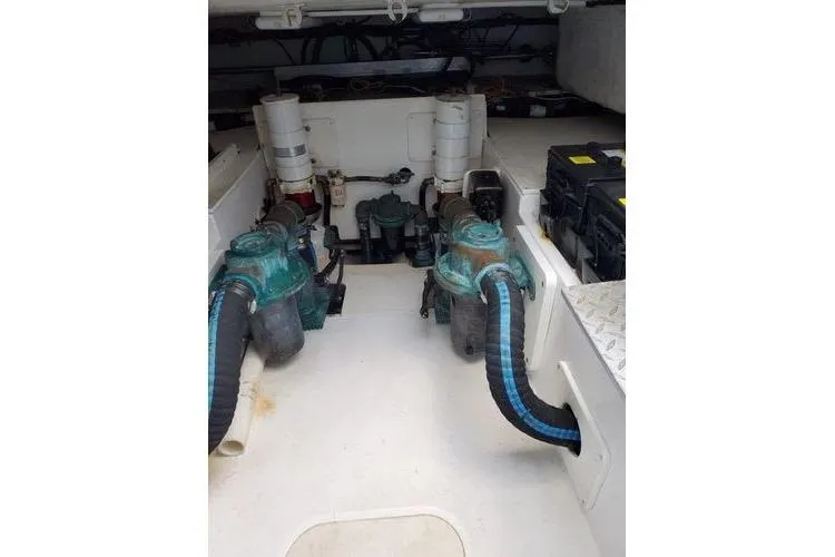 Slide: The Image of Engine room of 2005 Luhrs 41 Convertible boat, featuring dual engines and equipment. - 17