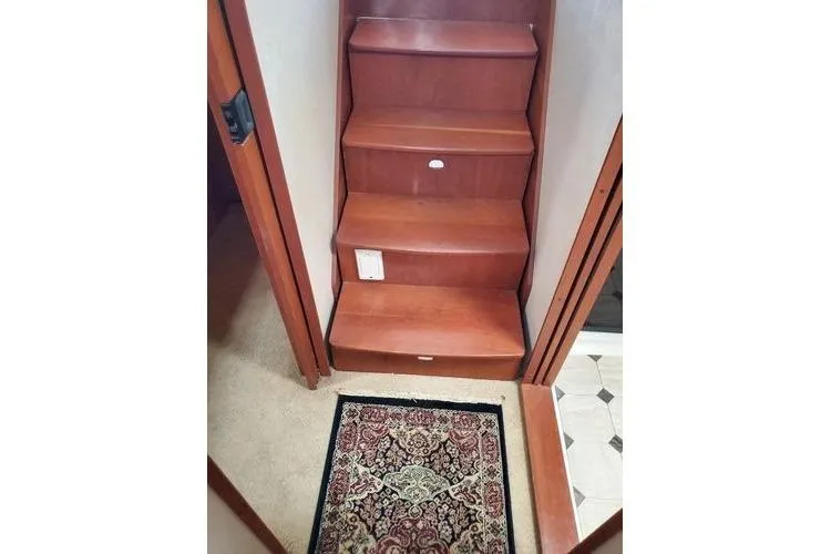 Slide: The Image of Staircase inside 2005 Luhrs 41 Convertible boat with decorative rug. - 19