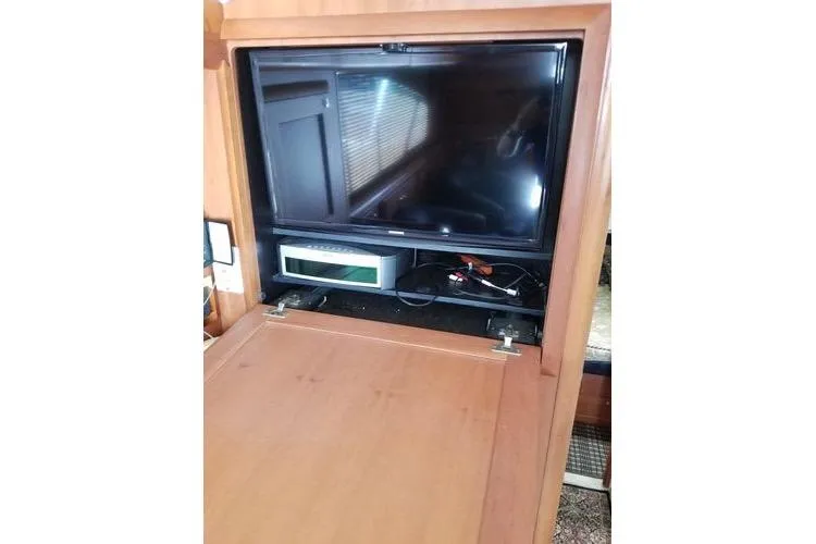 Slide: The Image of 2005 Luhrs 41 Convertible yacht interior with built-in TV and entertainment system. - 21