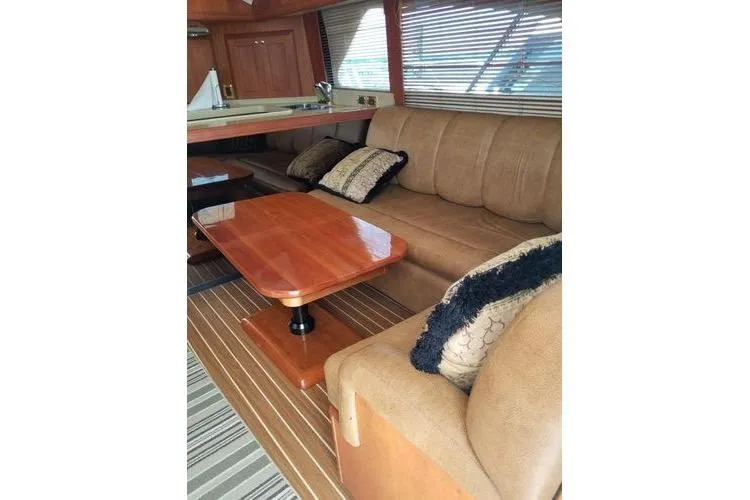 Slide: The Image of Luxurious interior of 2005 Luhrs 41 Convertible yacht with plush seating and wooden table. - 26