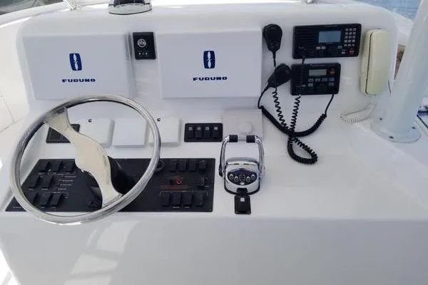 Slide: The Image of Control panel of 2005 Luhrs 41 Convertible boat with steering wheel and navigation equipment. - 28