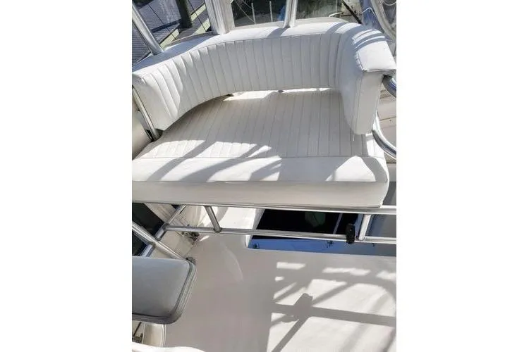 Slide: The Image of 2005 Luhrs 41 Convertible boat with white cushioned seating area. - 35