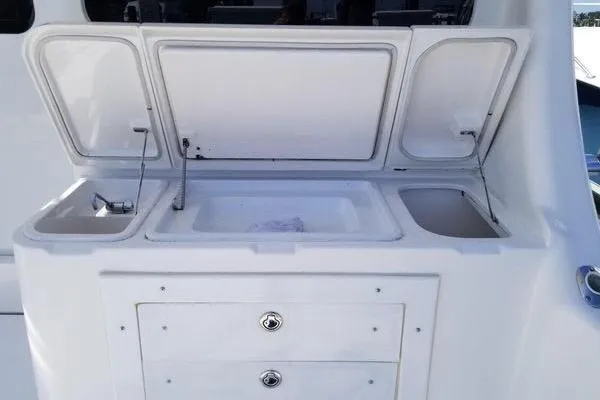 Slide: The Image of 2005 Luhrs 41 Convertible yacht sink and storage area with open compartments. - 36