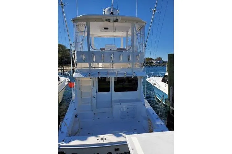 Slide: The Image of 2005 Luhrs 41 Convertible yacht docked, featuring spacious deck and flybridge. - 37