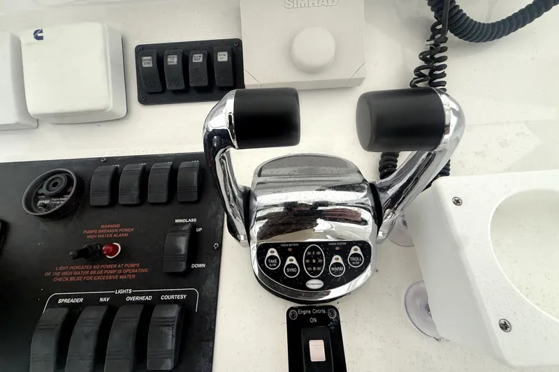 Slide: The Image of Control panel of a 2004 Luhrs 41 Convertible boat with throttle and switches. - 38
