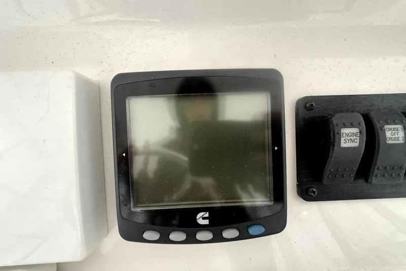 Slide: The Image of 2004 Luhrs 41 Convertible boat dashboard with display and engine controls. - 39