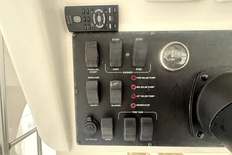 Slide: The Image of Control panel of a 2004 Luhrs 41 Convertible boat with switches and fuel gauge. - 41