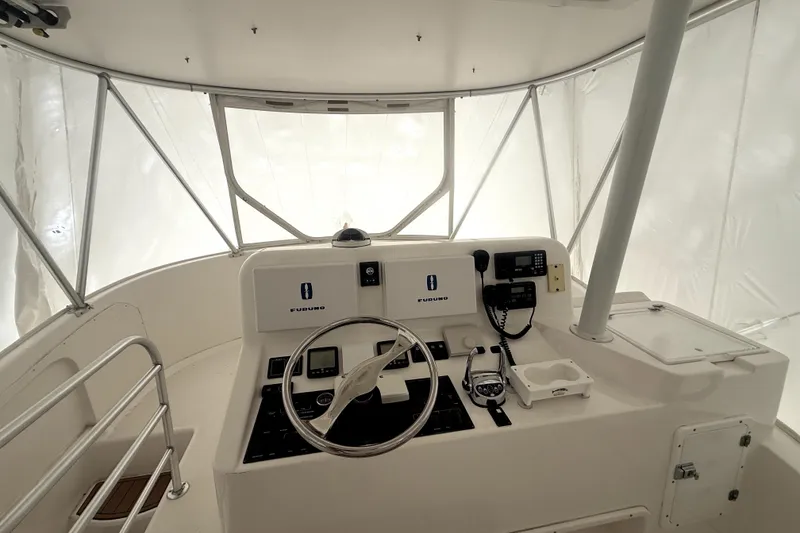 Slide: The Image of 2004 Luhrs 41 Convertible boat helm with steering wheel and navigation equipment. - 49