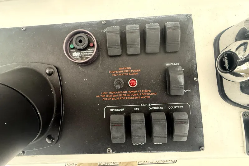 Slide: The Image of Control panel of a 2004 Luhrs 41 Convertible boat with various switches and indicators. - 53