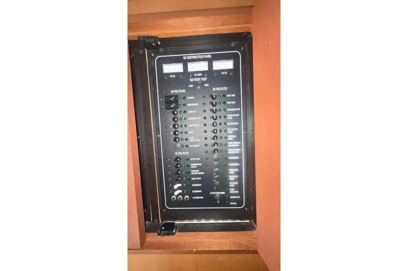 Slide: The Image of Electrical panel of 2004 Luhrs 41 Convertible boat, featuring various switches and indicators. - 56