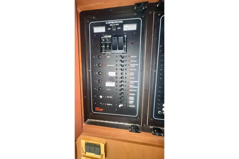Slide: The Image of Electrical panel on a 2004 Luhrs 41 Convertible boat, featuring various switches and controls. - 57