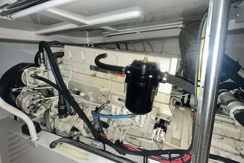 Slide: The Image of Engine compartment of a 2004 Luhrs 41 Convertible boat, showcasing mechanical components. - 59